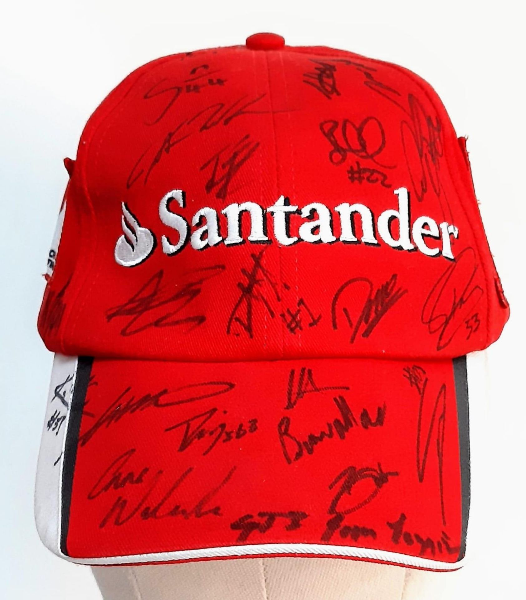 An Official Ferrari Team Cap - Over 20 signatures including Ferrari drivers and team principals.
