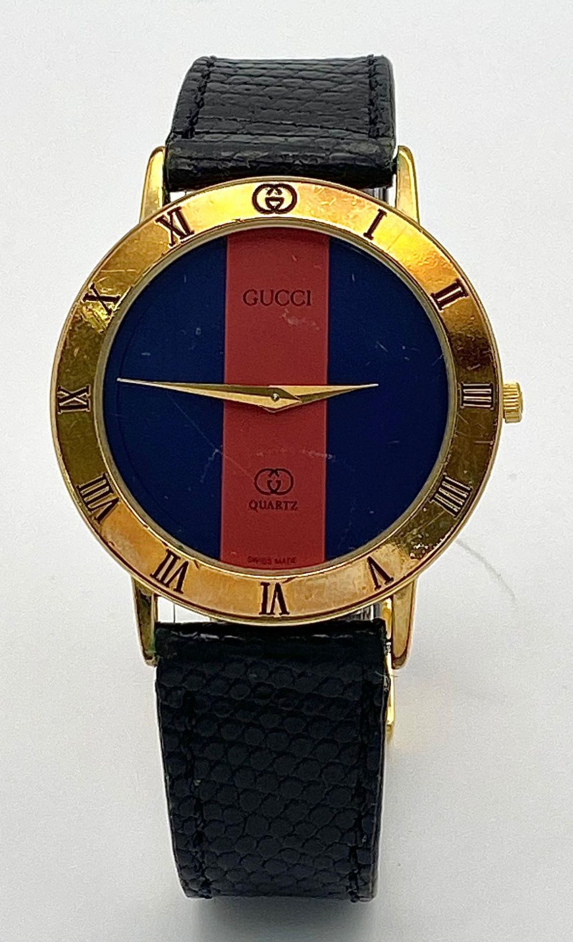 An iconic GUCCI watch with original lizard skin strap. Case: 33 mm, red/blue dial with gold coloured - Image 2 of 6