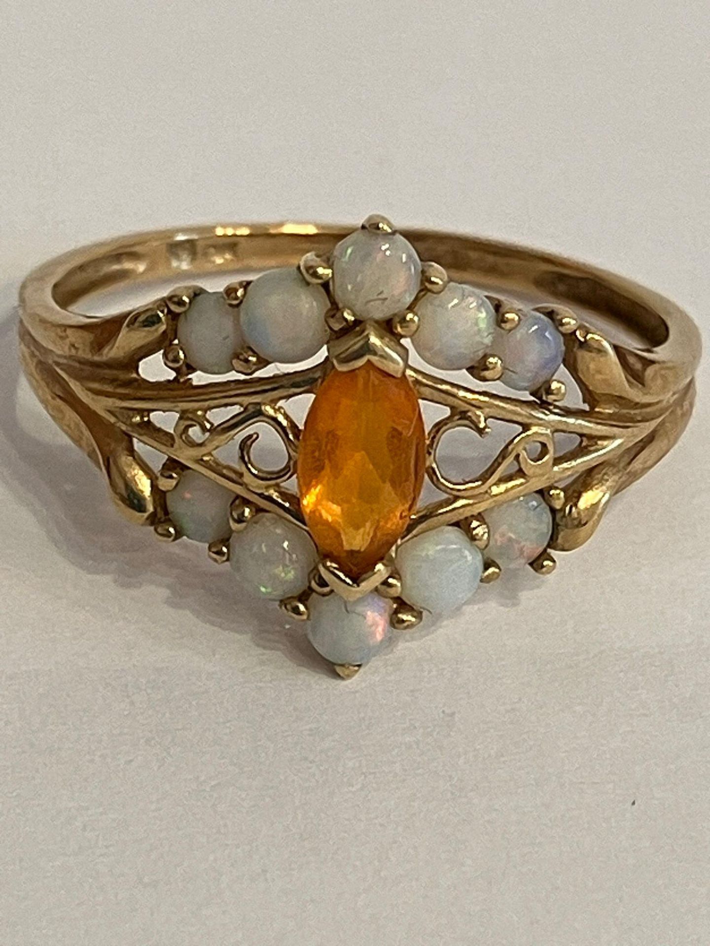 9 carat YELLOW GOLD RING,set with OPAL and Orange Baguette. Having attractive GOLD filigree detail