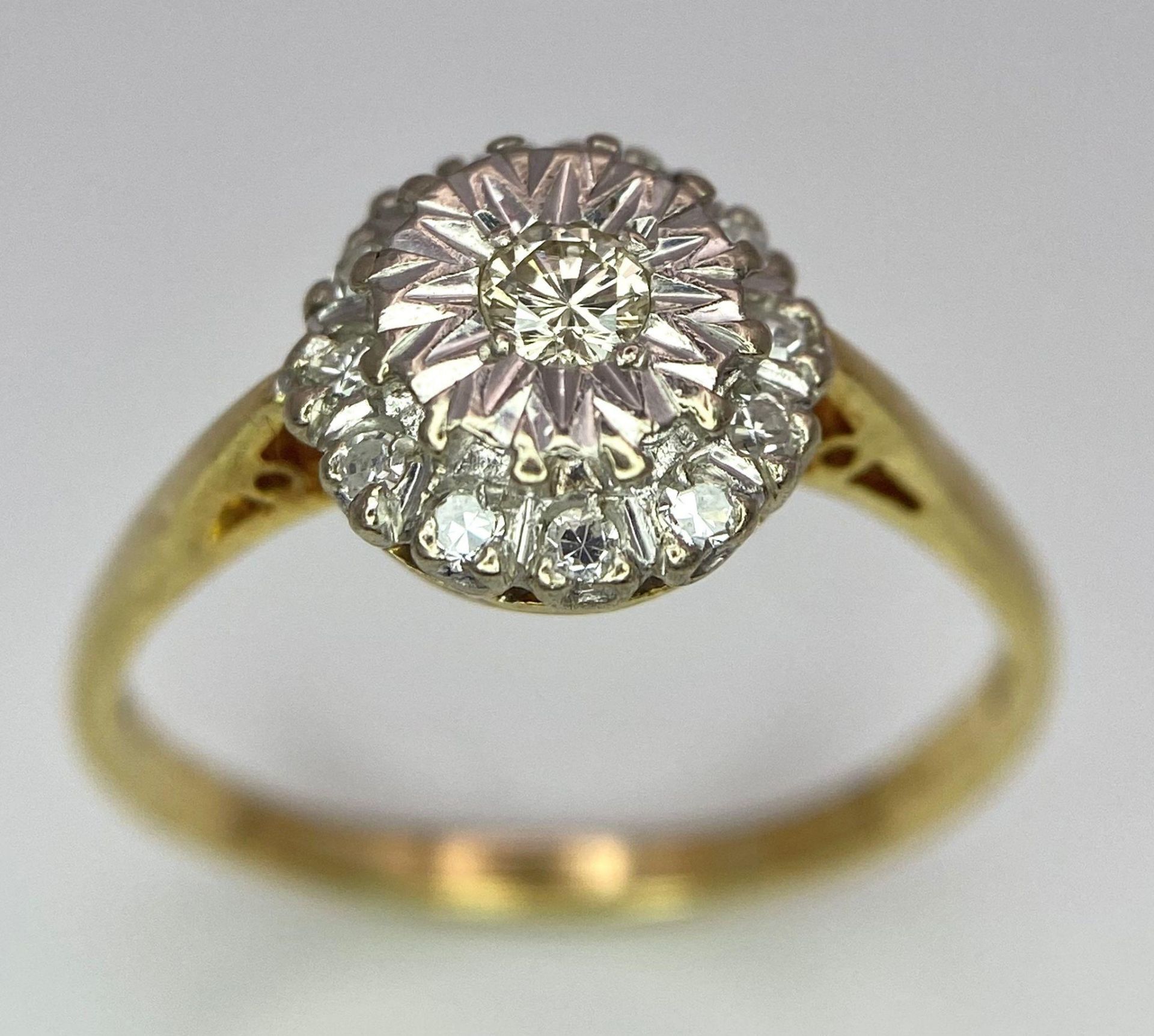 An 18 K yellow gold ring with a diamond cluster, size: P, weight: 3 g.