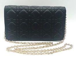 A Lady Dior pouch bag in black lambskin, gold tone hardware to include a removable chain shoulder