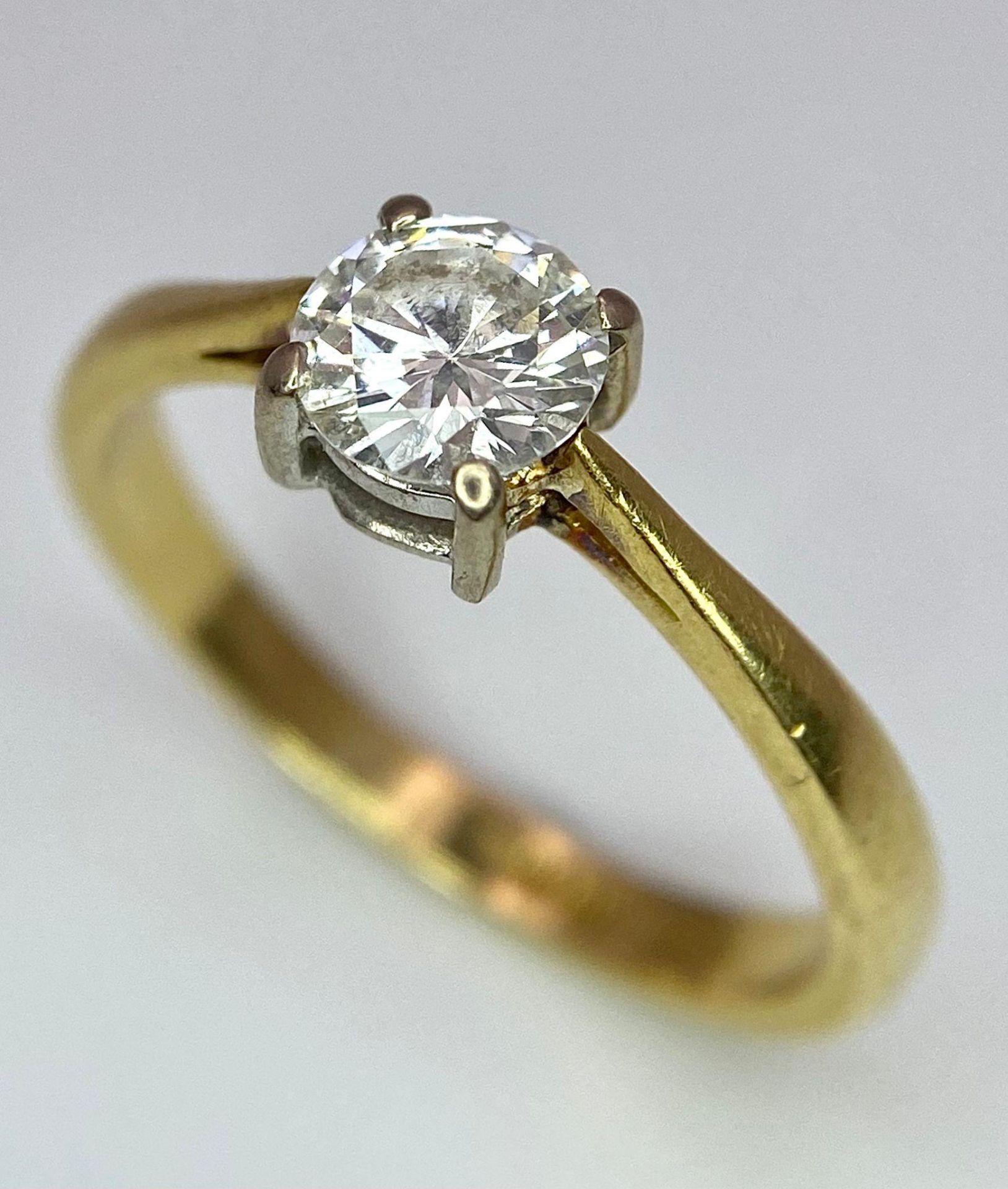 An 18K Yellow Gold Diamond Solitaire Ring. Brilliant round cut - 0.45ctw. 2.5g total weight. Size L.
