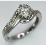A 9K WHITE GOLD 0.25CT DIAMOND CLUSTER RING. TOTAL WEIGHT 2.4G. SIZE L