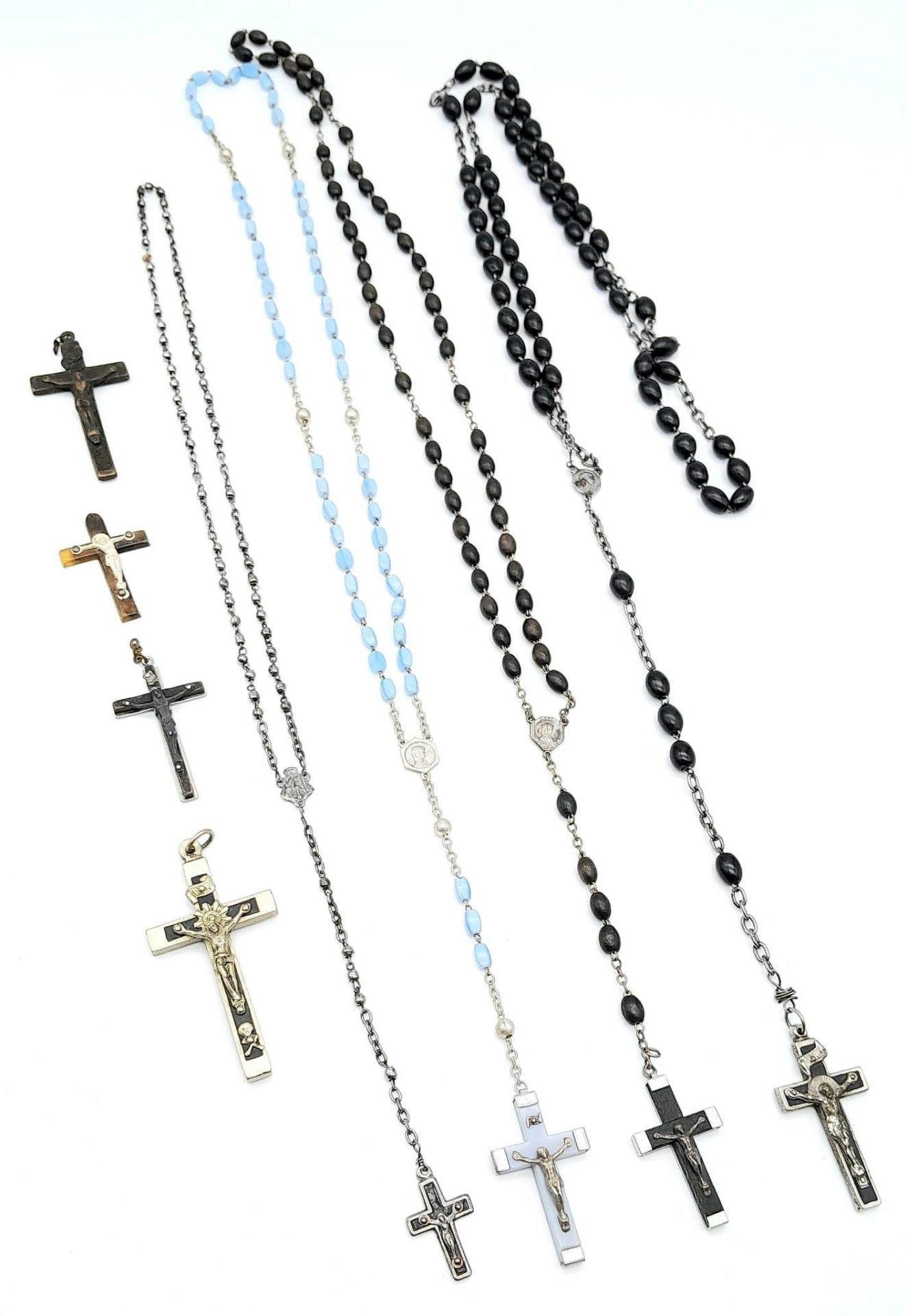 A Small Collection of Crucifix Pendants and Prayer Beads. All kept in a small decorative wood box.