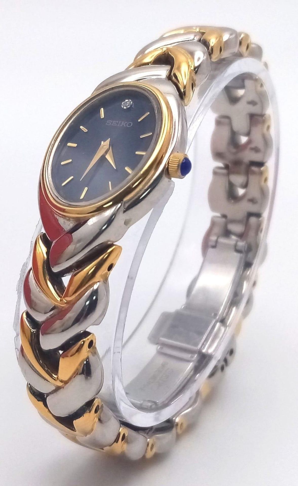 A Seiko Quartz Ladies Watch. Two tone strap and case - 19cm. Blue dial. In good condition and