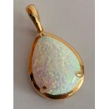 14 carat GOLD and OPAL PENDANT. Having a large pear-shaped WHITE FIRE OPAL Set in 14 carat gold