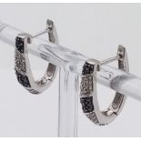 An interesting , 9 K white gold pair of earrings with black and white diamonds, length: 20 mm,