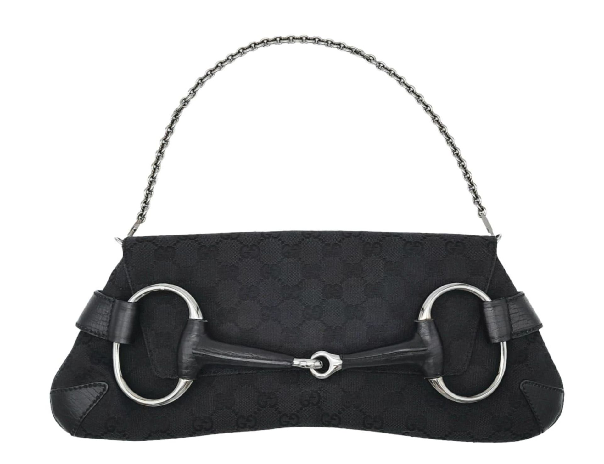 A Gucci GG black canvas bag featuring the black and gunmetal grey horsebit and metal shoulder strap.