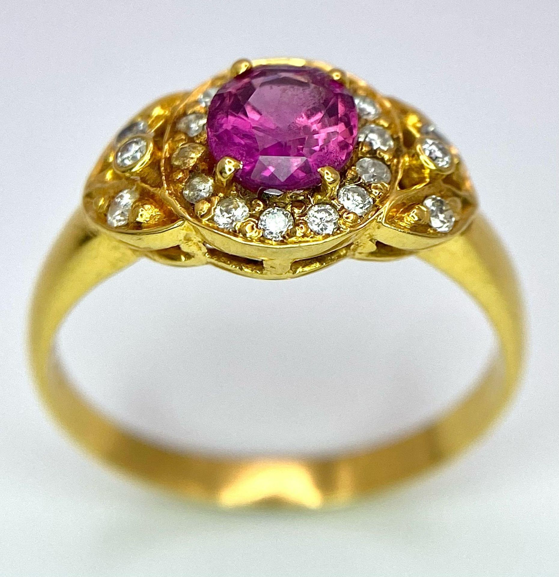 An 18K Yellow Gold Pink Sapphire and Diamond Ring. Central oval sapphire with diamond halo and - Image 2 of 12