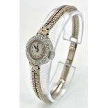 A ladies, platinum watch with diamond bezel and a 9 K white gold double snake chain bracelet. The