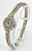 A ladies, platinum watch with diamond bezel and a 9 K white gold double snake chain bracelet. The