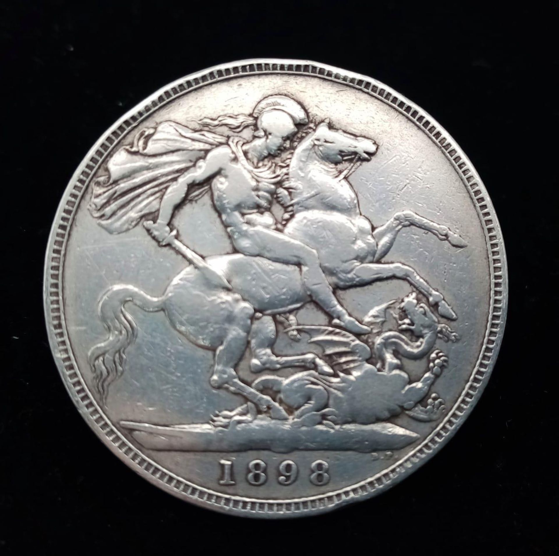 An 1898 Queen Victoria Silver Crown Coin. VF grade but please see photos.
