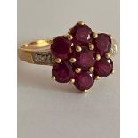 9 carat GOLD,DIAMOND and TOURMALINE RING. Having Tourmaline gemstones set to top in a floral cluster