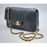 An Early 1990s Chanel Mademoiselle Classic Flap Chain Bag. Black lambskin leather. Gold plated