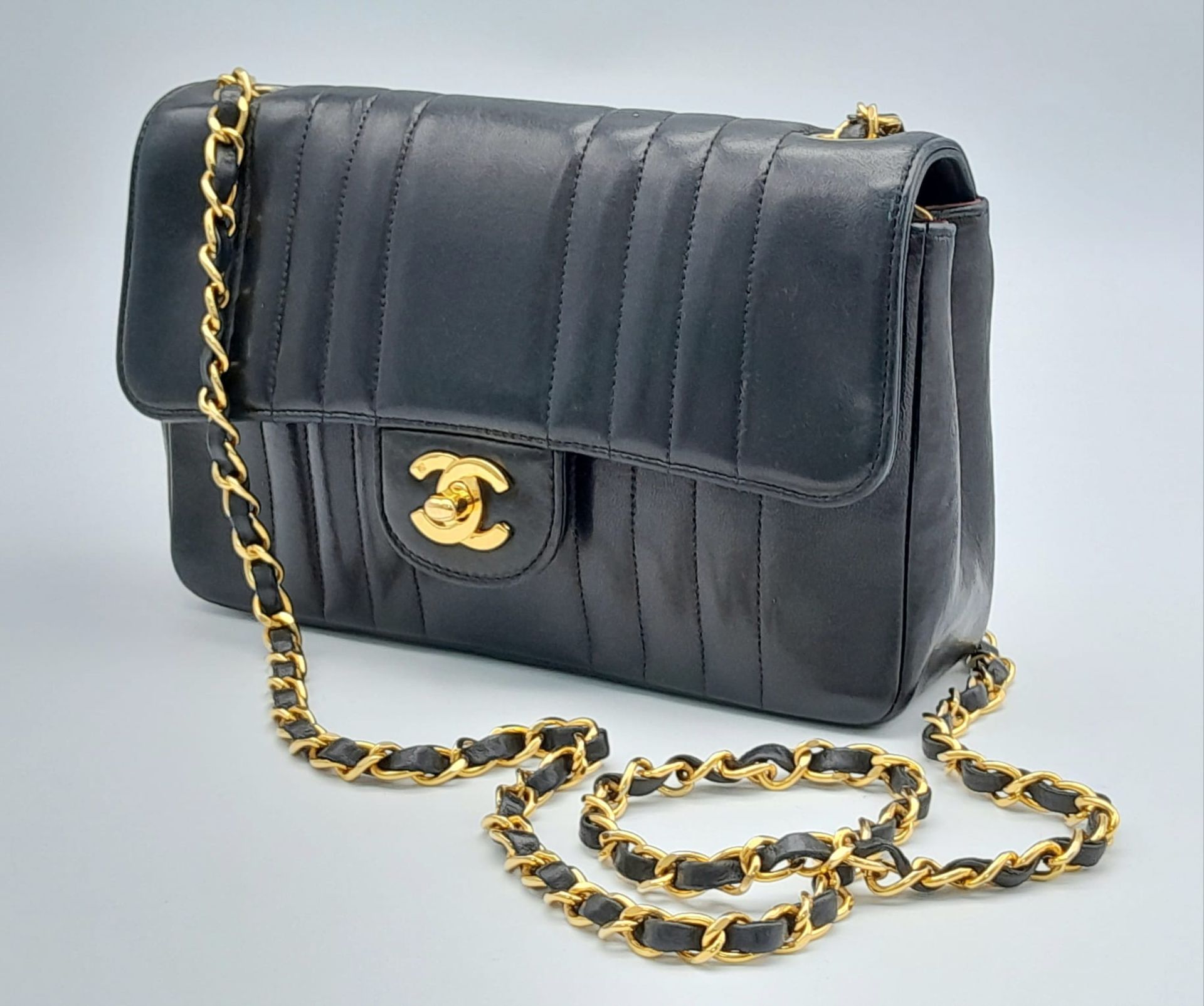 An Early 1990s Chanel Mademoiselle Classic Flap Chain Bag. Black lambskin leather. Gold plated