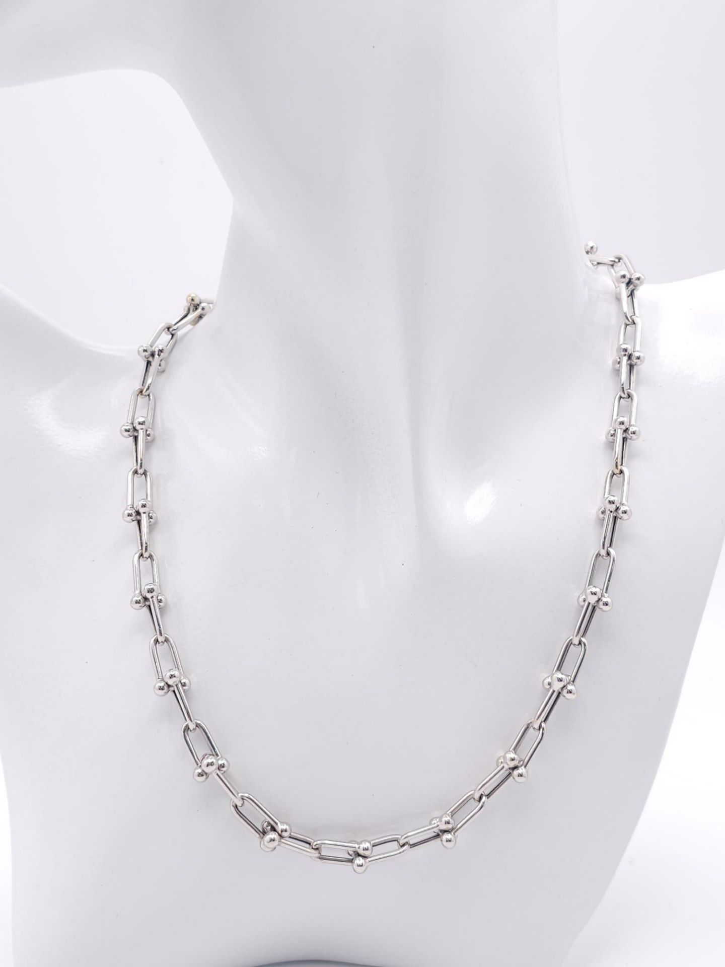A Tiffany and Co. 18K White Elongated Link Necklace. Tiffany markings on clasp. 42cm length. 17.
