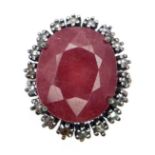 A Ruby Ring with a Halo of Diamonds on 925 Silver. 12.65ct ruby, 0.50ctw diamonds. Size P, 7.21g