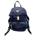 A Prada Navy Blue Mini Backpack. Textile exterior with silver-toned hardware, leather top handle,