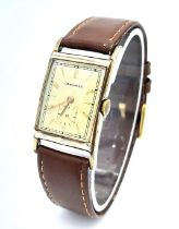 A Vintage Mechanical Longine Gents Watch. Brown leather strap. Gold filled tank case - 23mm. Gold
