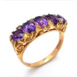 A HIGHLY ORNATE 5 AMETHYST STONE RING SET IN 9K GOLD . 4.2gms size O