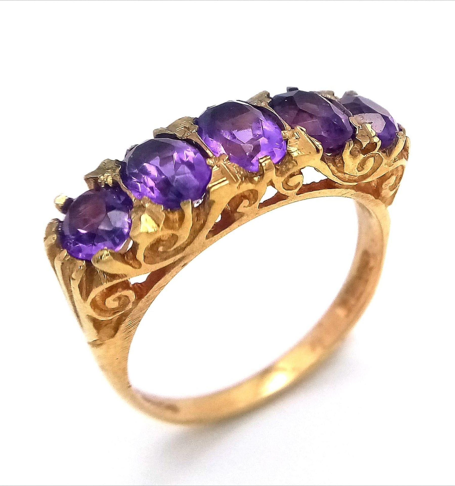 A HIGHLY ORNATE 5 AMETHYST STONE RING SET IN 9K GOLD . 4.2gms size O