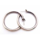 A vintage pair of sterling silver hoop earrings. Total weight 9.85G.