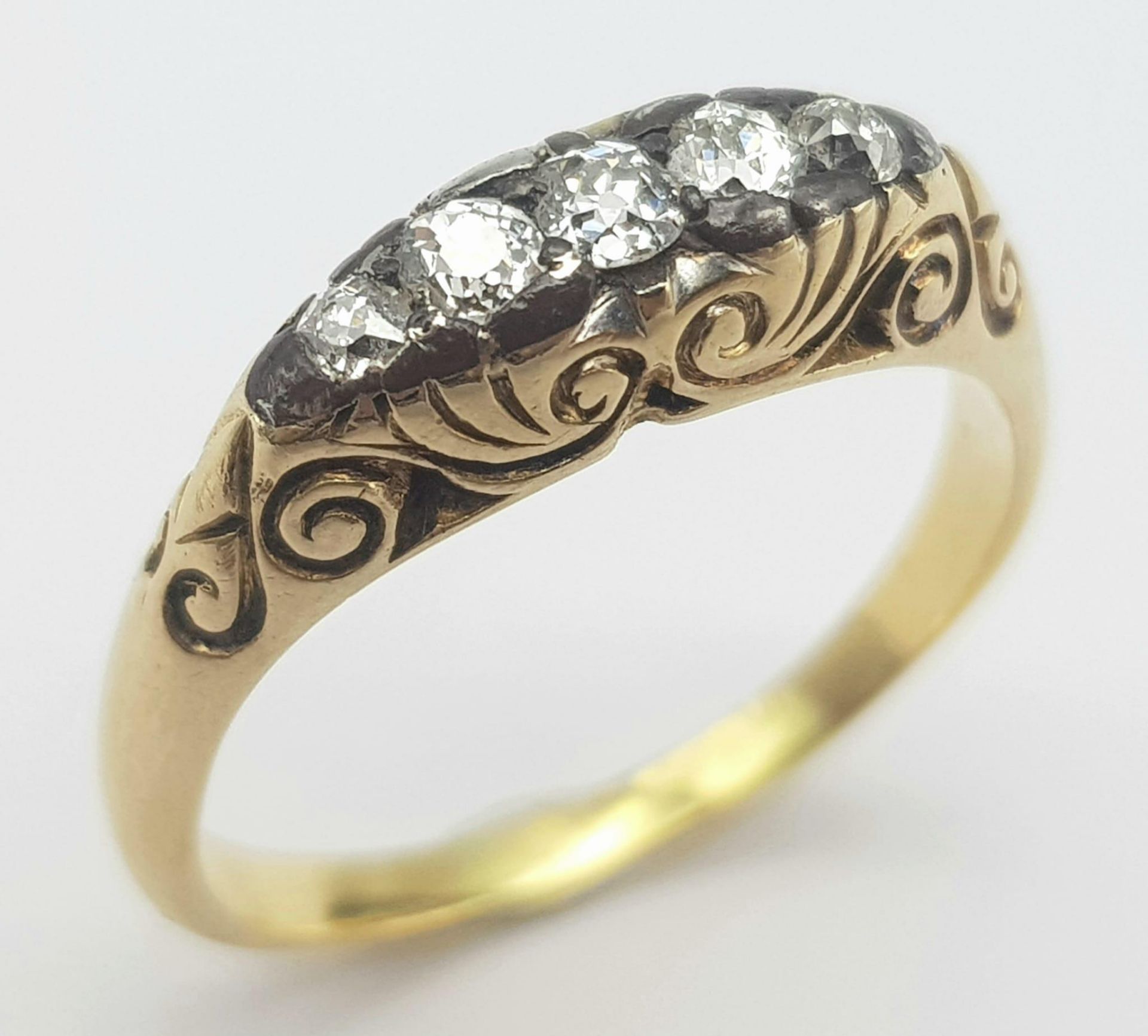 An 18K Yellow Gold Diamond Gypsy Ring. 0.15ctw diamonds. Size P. 4.9g total weight.