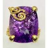 A fabulous silver and 18 K yellow gold-plated ring carrying a customised-cut, mesmerising amethyst