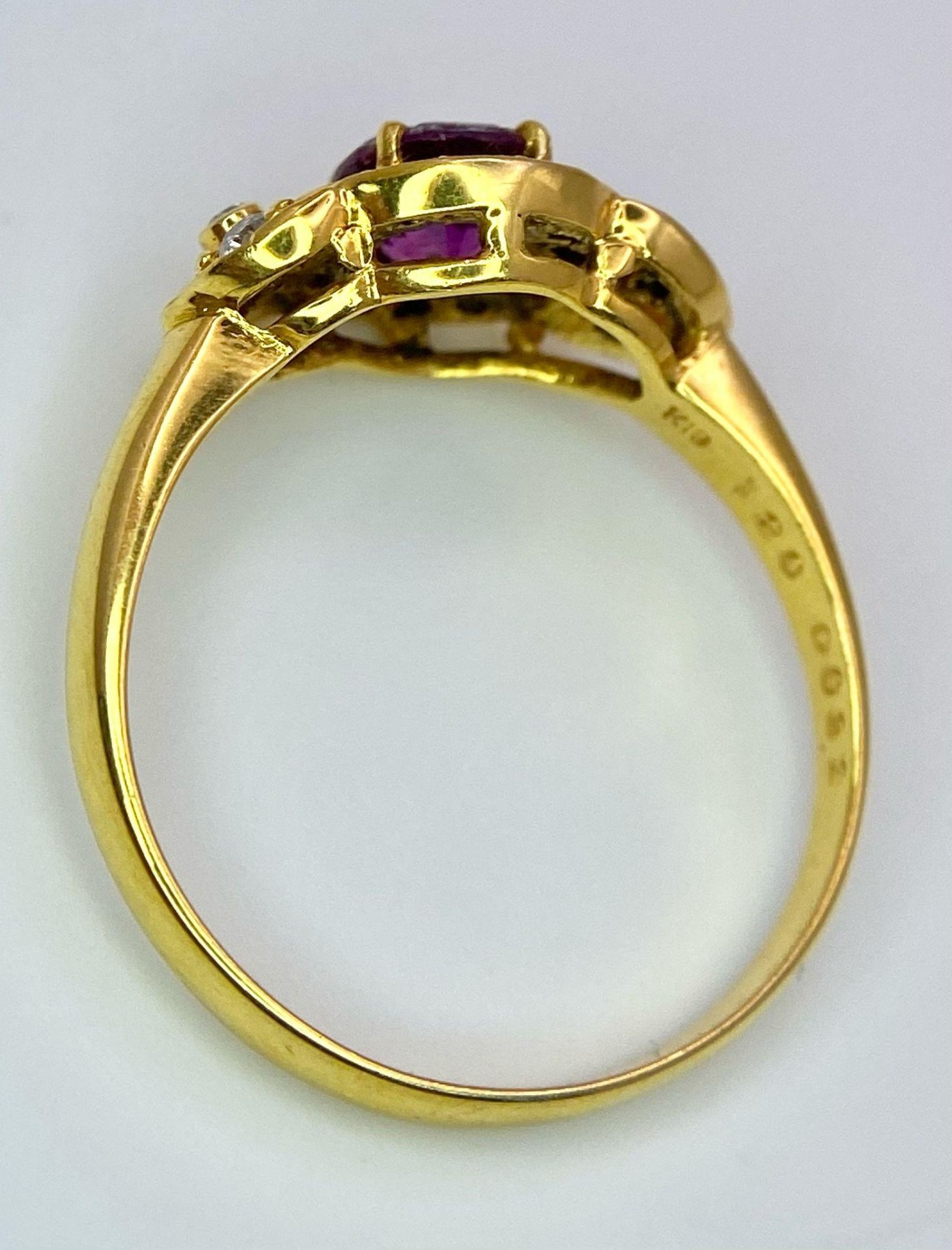 An 18K Yellow Gold Pink Sapphire and Diamond Ring. Central oval sapphire with diamond halo and - Image 10 of 12