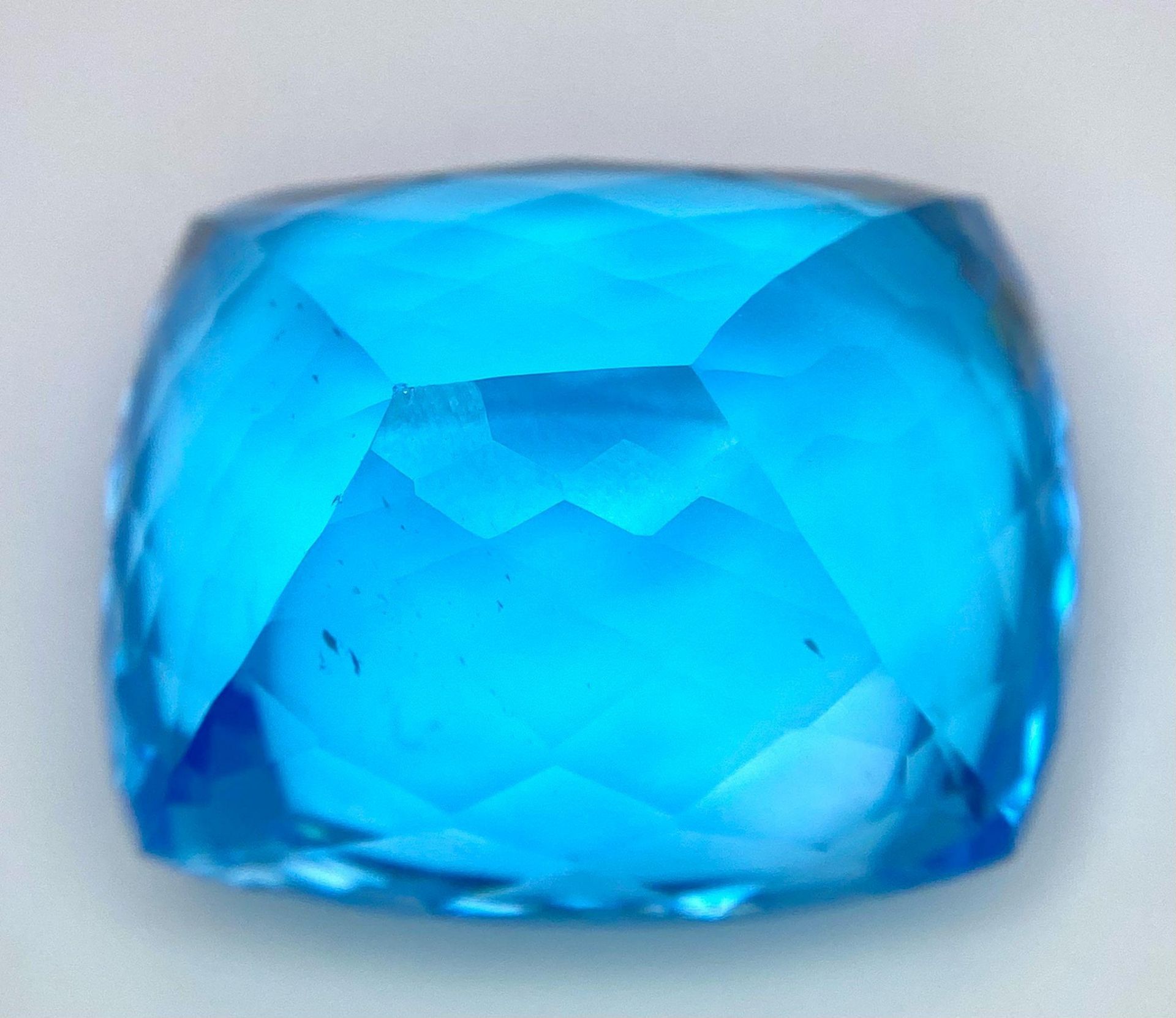 A Huge 142ct London Blue Topaz Natural Gemstone. Rectangular cushion cut. 33mm x 28mm. No visible - Image 6 of 7