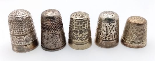 A collection of 5 antique thimbles with multiple sizes and different designs. Some of them come with