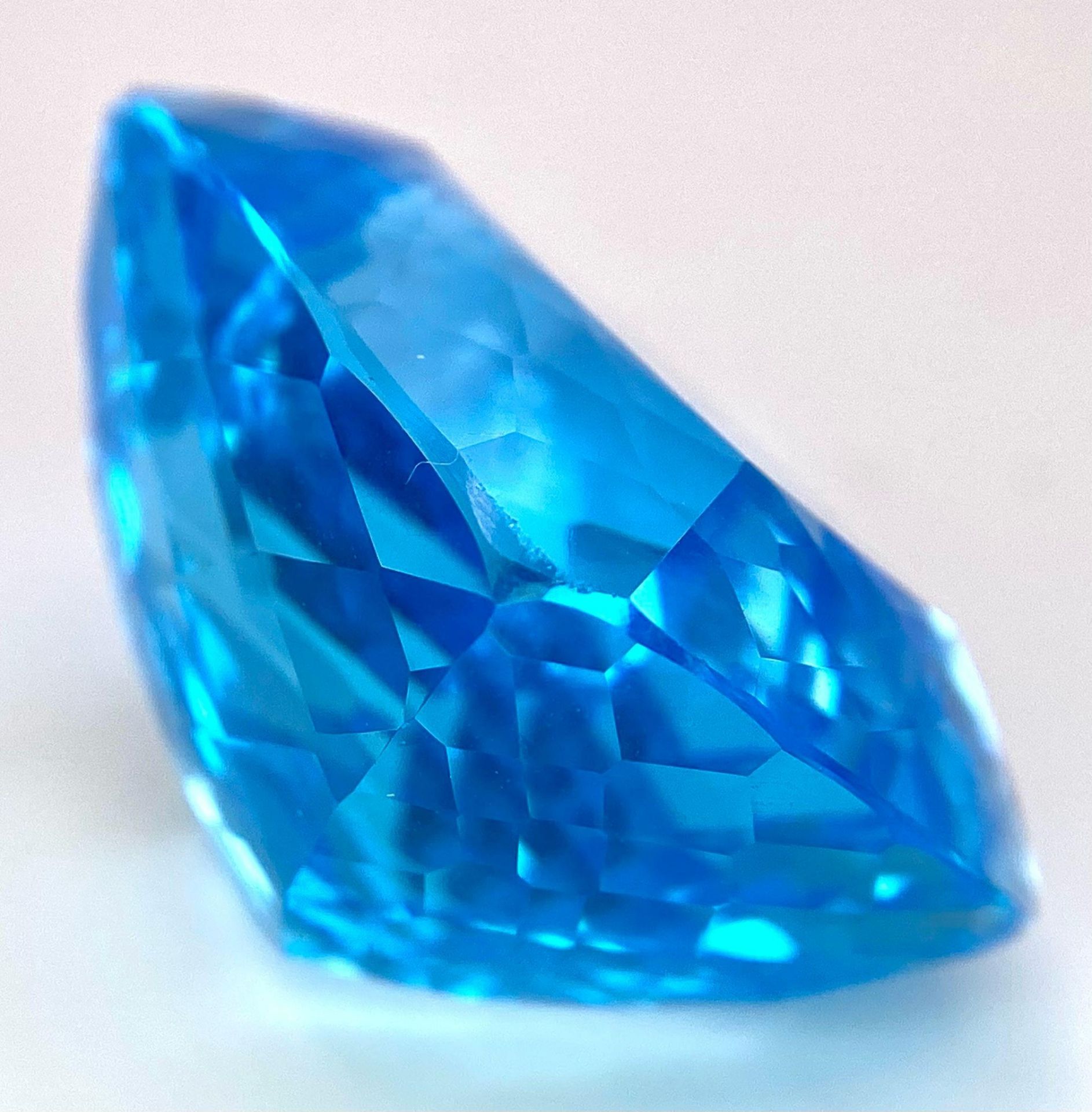 A Huge 142ct London Blue Topaz Natural Gemstone. Rectangular cushion cut. 33mm x 28mm. No visible - Image 3 of 7