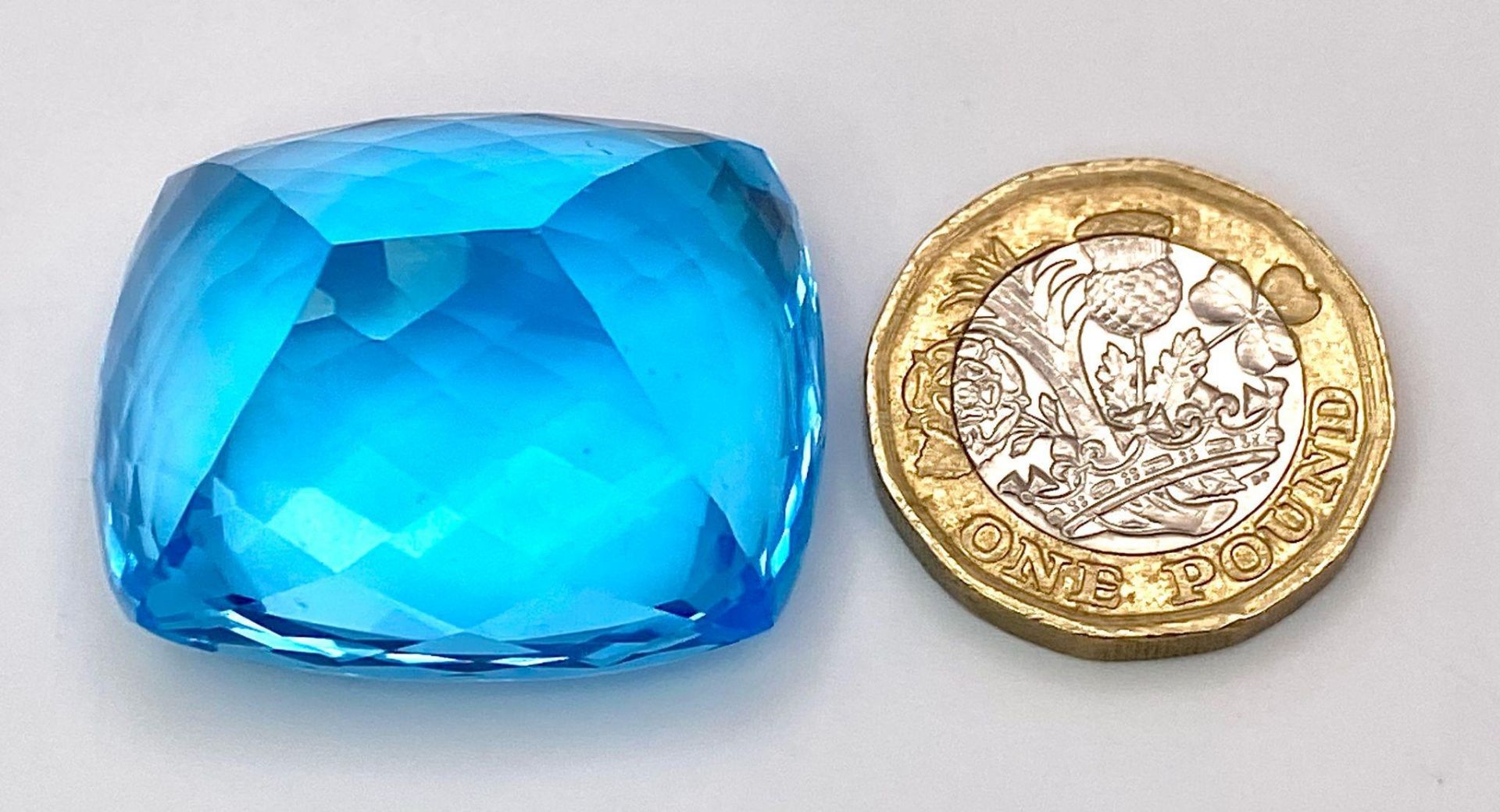 A Huge 142ct London Blue Topaz Natural Gemstone. Rectangular cushion cut. 33mm x 28mm. No visible - Image 7 of 7