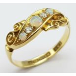 An antique, 18 K yellow gold ring with two round cut diamonds between three wonderful round opal