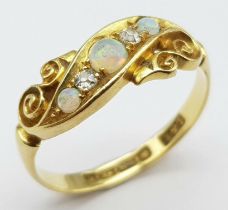 An antique, 18 K yellow gold ring with two round cut diamonds between three wonderful round opal
