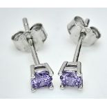 A sterling silver pair of stud earrings with a round cut amethyst each, weight: 0.5 g.