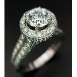 An 18 K white gold ring with a brilliant cut diamond (1.01 carats) surrounded by diamonds on the top