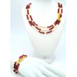 A very glamorous three row necklace and bracelet set with multi-faceted rubies and large, pink,