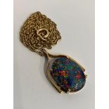 Stunning 9 carat GOLD, OPAL SET PENDANT and CHAIN. Having a large oval black fire lab OPAL in a 9 ct