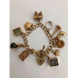 Vintage 9 carat GOLD CHARM BRACELET having a selection of Gold Charms to include a Blue £1 note.