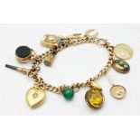 A Vintage 9K Yellow Gold Charm Bracelet. Includes: Diamond heart, carnelian fob and St