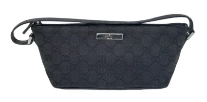 A Gucci Black Monogram Pochette Boat Bag. Textile exterior with black and silver-toned hardware,