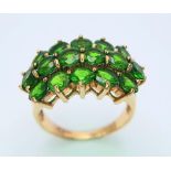 A 9 K yellow gold ring with a cluster of round cut peridots arranged over three rows. Size: L,