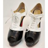 A Pair of Louboutin high heels in black and white leather. Lightly used. Size 40.