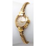 A Vintage Omega 18K Gold Ladies Watch. 18k gold bracelet and case - 17mm. Patinaed dial.