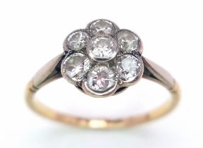 A Vintage 18K Yellow Gold Diamond Ring. Seven round cut diamonds in a floral shape. Size P. 2.52g