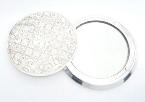 A white metal (untested) CRISTOFLE ladies mirror, diameter: 70 mm, weight: 138 g.