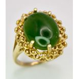 A Fine Oval Cut Green Jade Ring set in 14K gold. Size P. 5.83g total weight. Ref: T1R