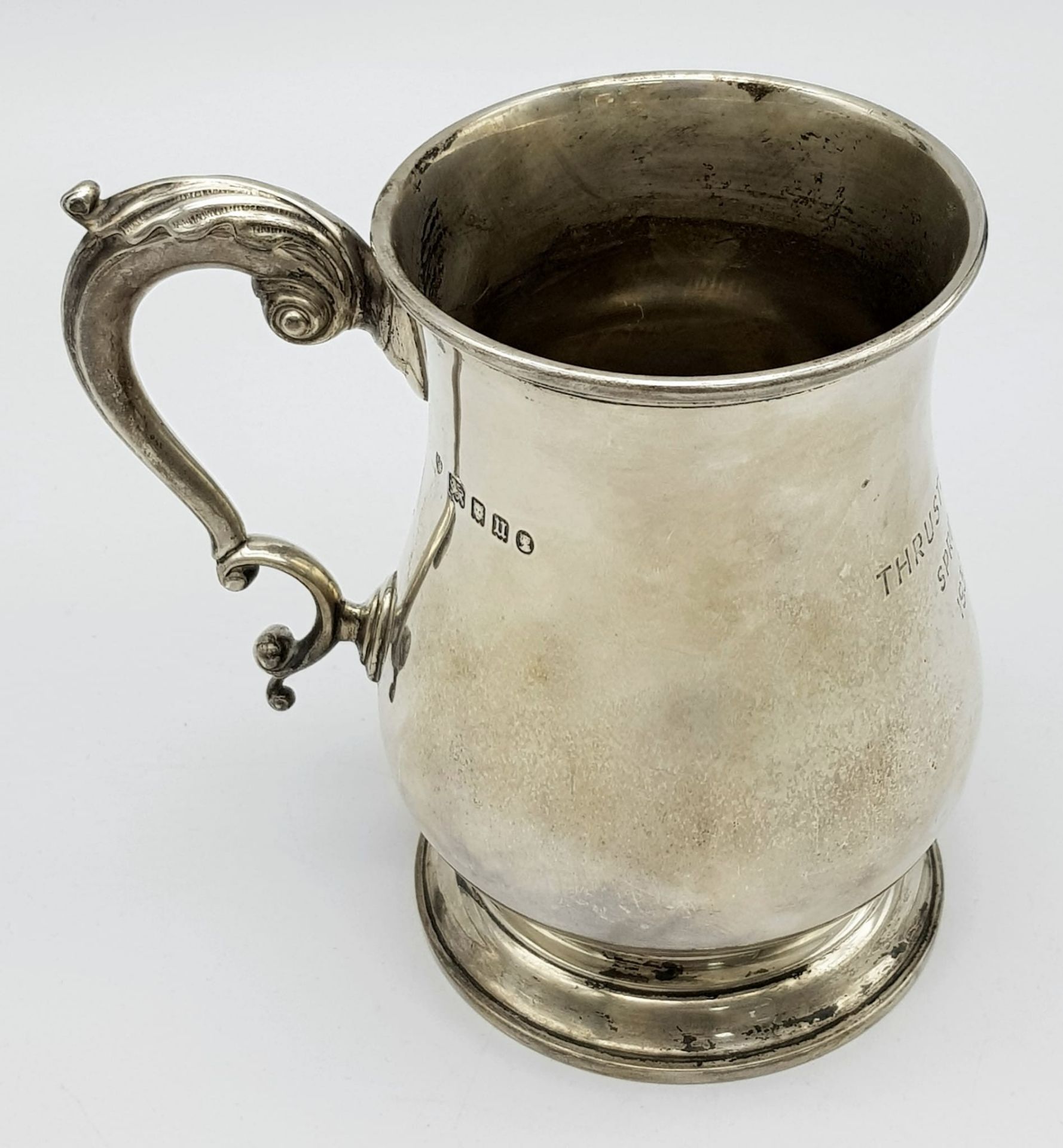 A Sterling Silver Tankard Given to the Thrusters! Hourglass design with an ornate handle.