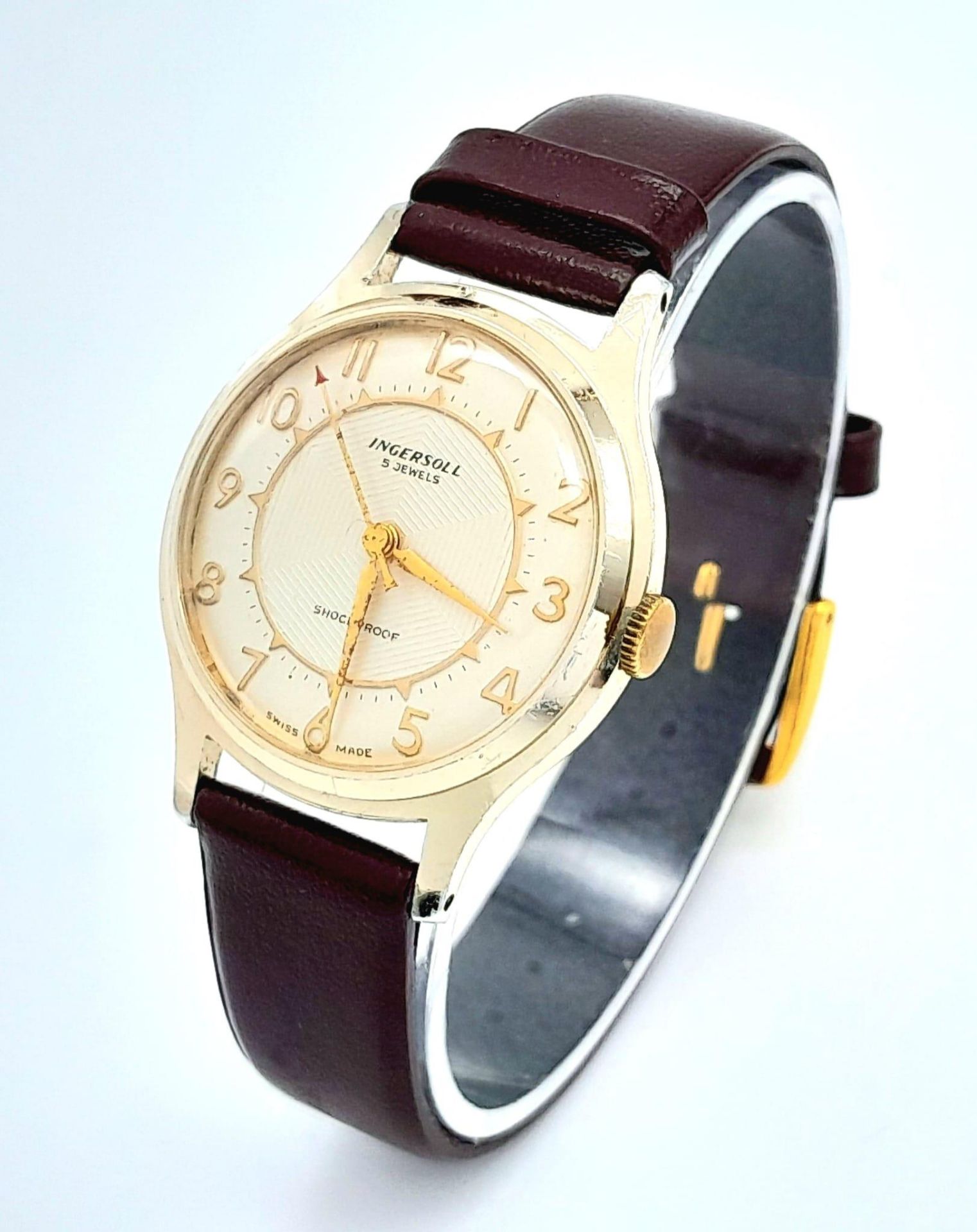 A Vintage Ingersoll Mechanical Gents Watch. Burgundy leather strap. Gilded case - 32mm. Cream